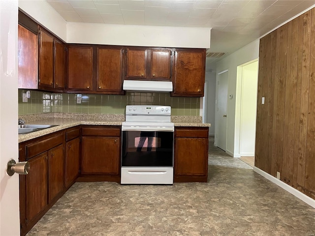 kitchen with wood walls, sink, white electric range oven, and decorative backsplash