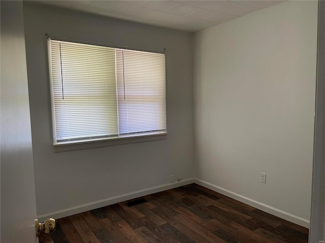 empty room featuring dark hardwood / wood-style flooring