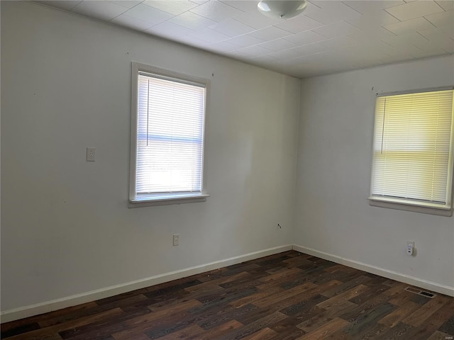 spare room featuring dark hardwood / wood-style flooring