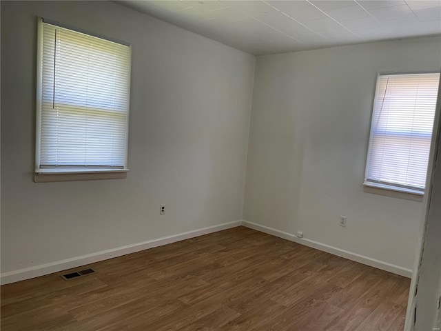 unfurnished room featuring hardwood / wood-style floors