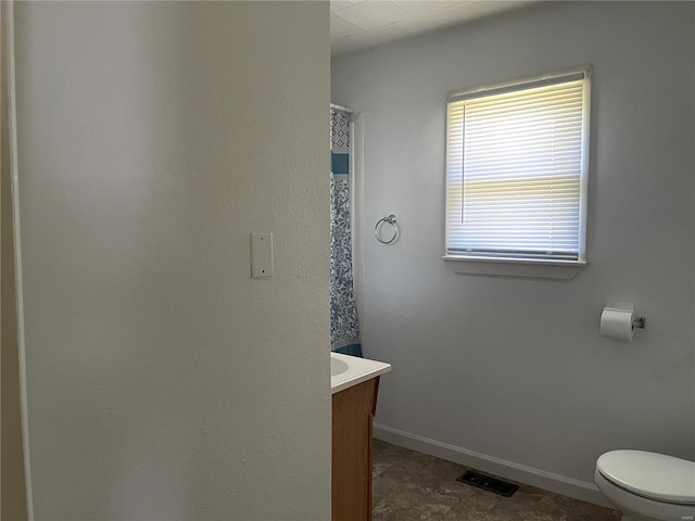 bathroom featuring vanity and toilet