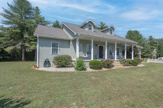 cape cod-style house with a porch, roof with shingles, a front yard, and fence