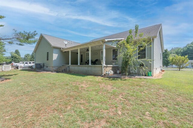 rear view of house with a yard, a patio area, and crawl space