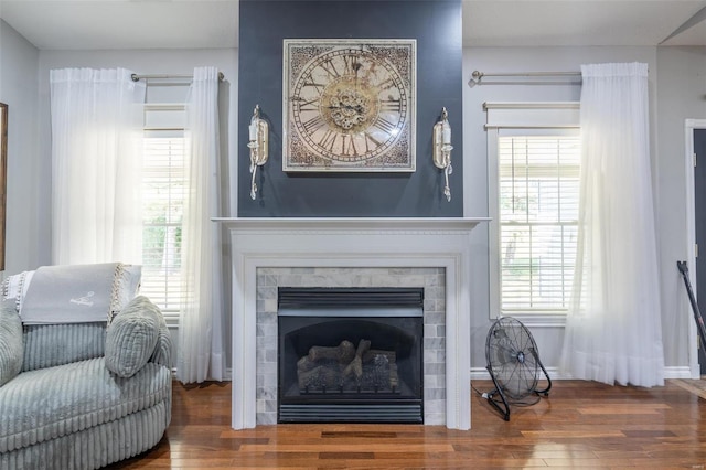 living area with a fireplace and wood finished floors