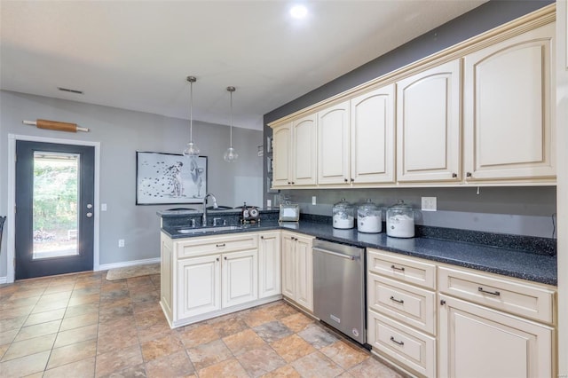 kitchen featuring cream cabinetry, a peninsula, a sink, and stainless steel dishwasher