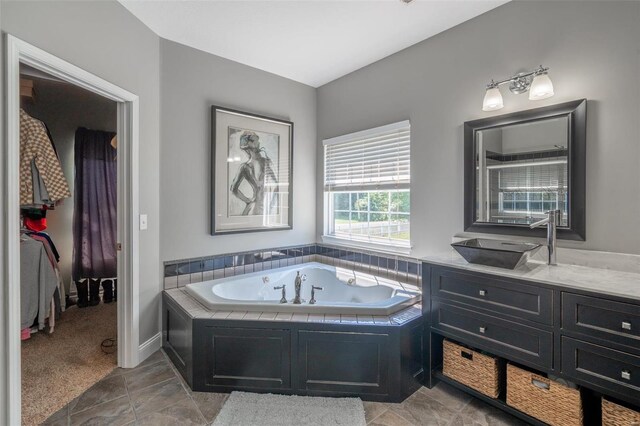 full bathroom featuring vanity and a whirlpool tub