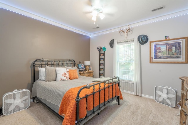 carpeted bedroom featuring visible vents, baseboards, and ceiling fan