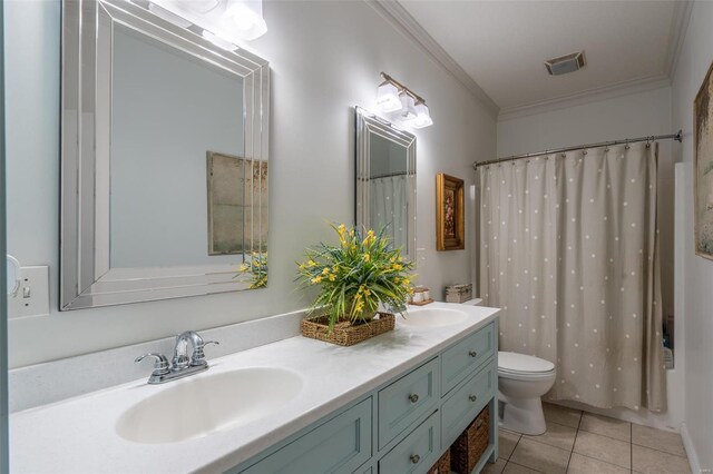 bathroom with tile patterned floors, toilet, a sink, crown molding, and double vanity