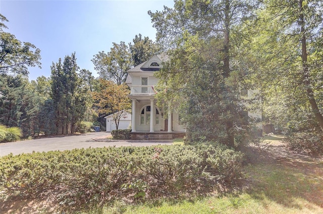 view of front of property with a garage and a balcony