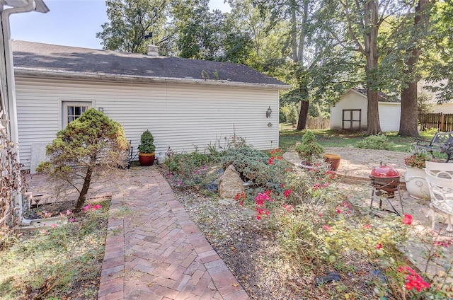 view of yard with a storage shed and a patio