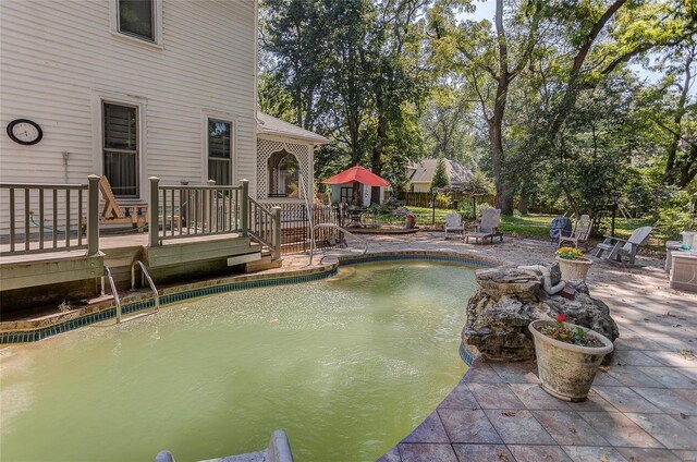 view of pool with a patio area and a deck