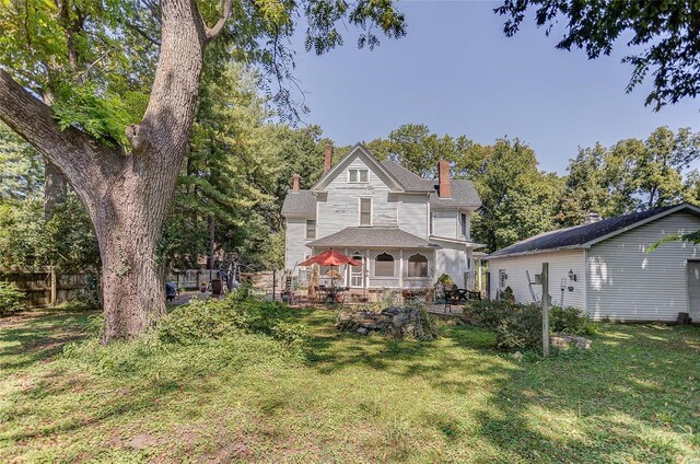 back of property featuring a yard