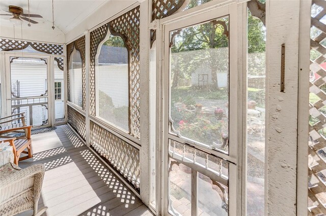 sunroom / solarium featuring lofted ceiling and ceiling fan