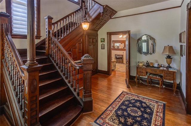 staircase featuring a textured ceiling and hardwood / wood-style floors