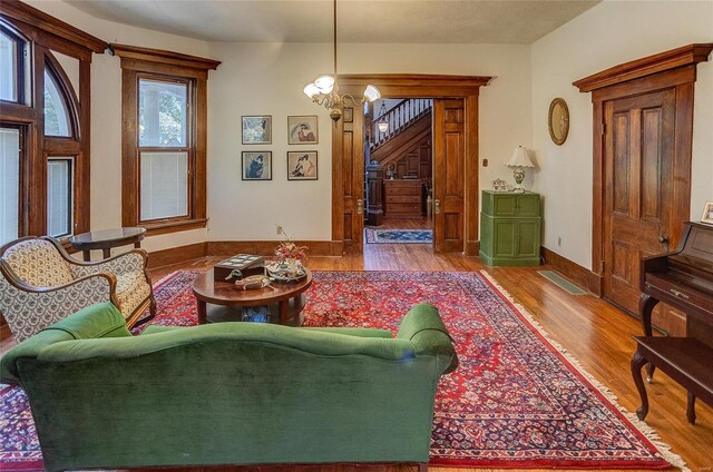 living room with hardwood / wood-style floors and an inviting chandelier