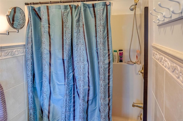 bathroom with tile walls and walk in shower