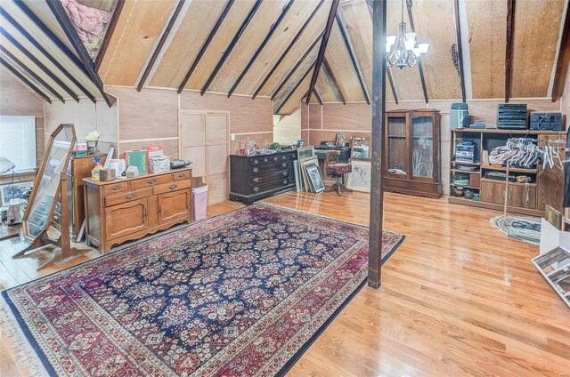 interior space featuring an inviting chandelier, light hardwood / wood-style flooring, and beam ceiling