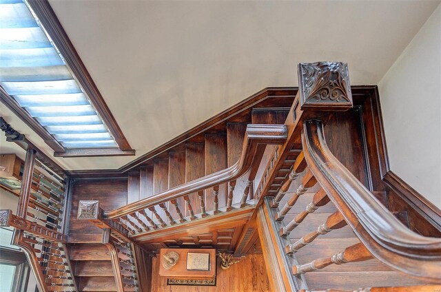 stairway featuring hardwood / wood-style floors and a towering ceiling