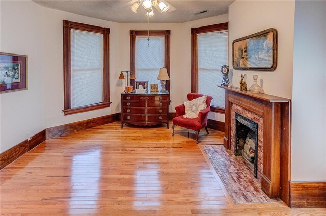 sitting room with ceiling fan and light hardwood / wood-style floors