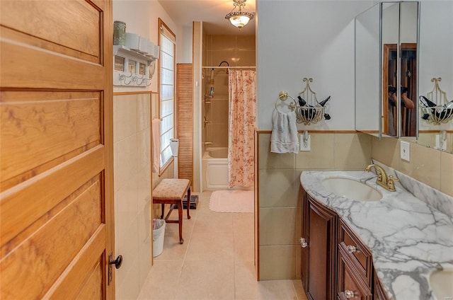 bathroom featuring a wealth of natural light, tile walls, shower / tub combo, and vanity