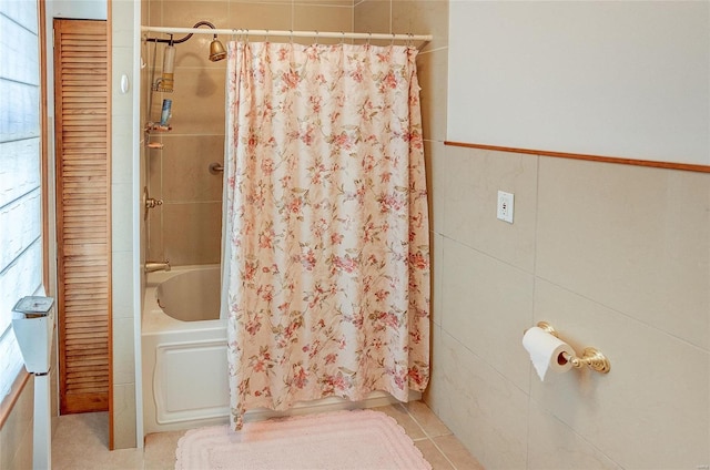 bathroom with tile patterned flooring, tile walls, and shower / tub combo with curtain