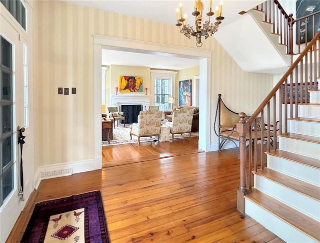 entryway featuring light hardwood / wood-style flooring and a chandelier