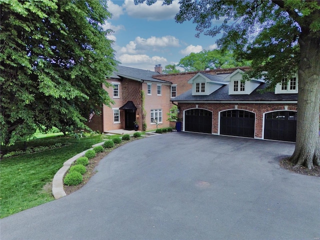 view of front facade featuring a garage and a front lawn