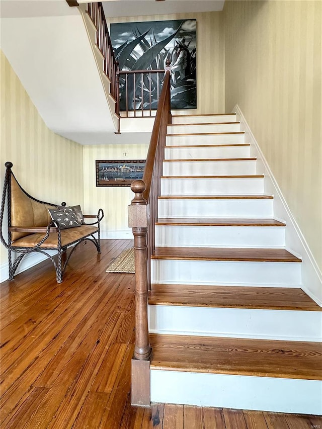 stairs featuring wood-type flooring