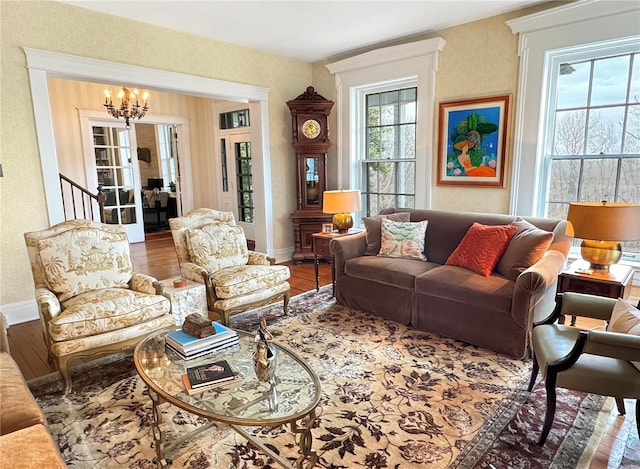 living room with hardwood / wood-style flooring and a notable chandelier