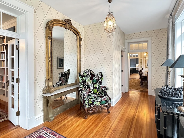 interior space featuring tile walls, a chandelier, and light hardwood / wood-style floors