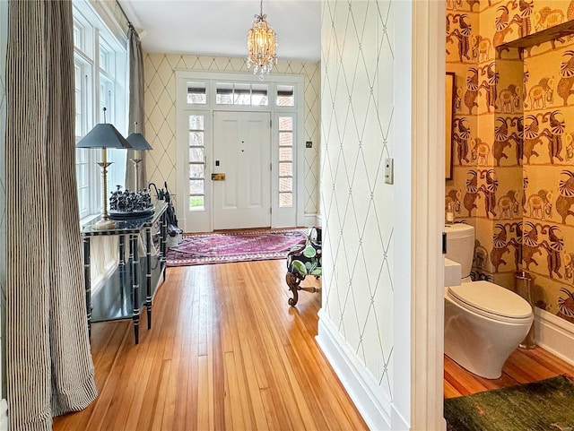 entrance foyer featuring an inviting chandelier and light hardwood / wood-style floors