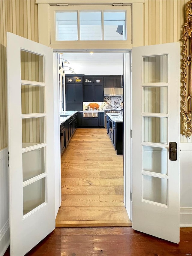 doorway with sink and hardwood / wood-style flooring