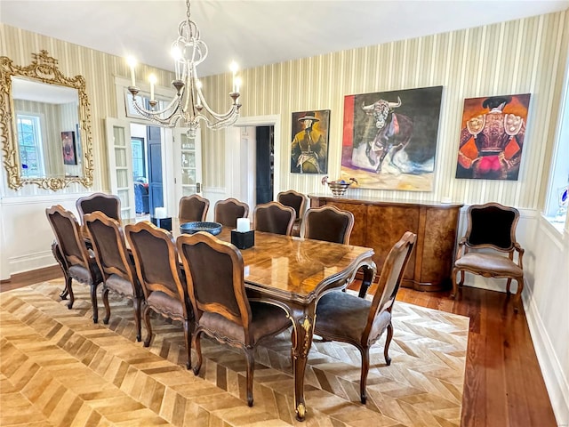 dining room featuring hardwood / wood-style floors and an inviting chandelier