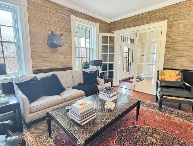 living room with hardwood / wood-style floors, ornamental molding, and french doors