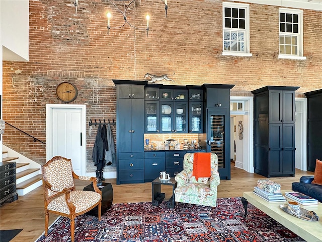 living room with light hardwood / wood-style flooring and brick wall