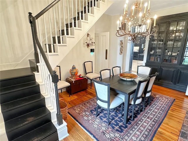 dining area with a notable chandelier and wood-type flooring