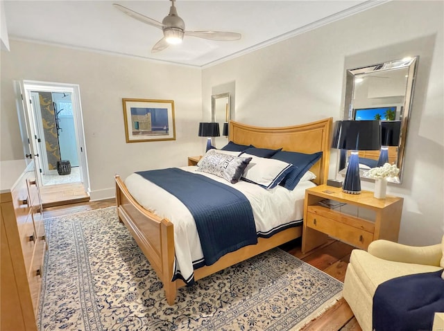 bedroom featuring crown molding, hardwood / wood-style floors, and ceiling fan