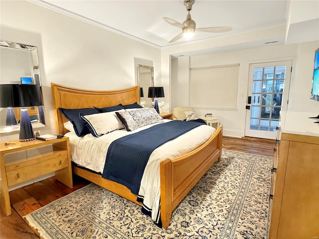 bedroom featuring ornamental molding, hardwood / wood-style floors, and ceiling fan