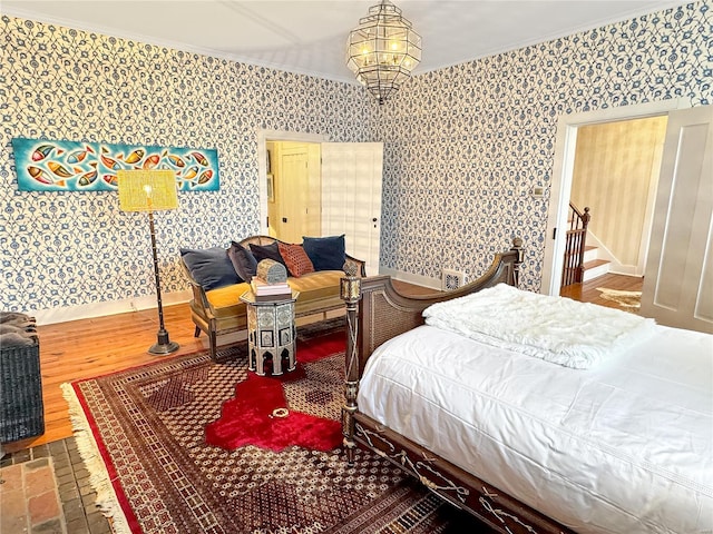 bedroom featuring ornamental molding and wood-type flooring