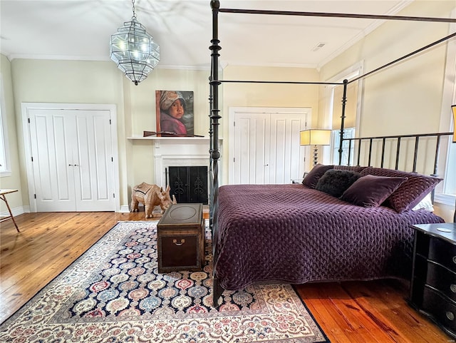 bedroom featuring dark hardwood / wood-style flooring and crown molding