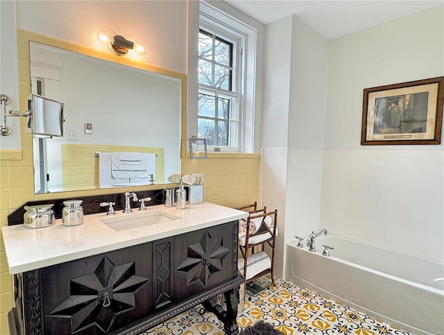 bathroom with vanity, a bath, tile walls, and tile patterned floors