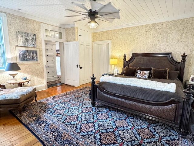 bedroom featuring wood ceiling, ceiling fan, ornamental molding, and hardwood / wood-style floors