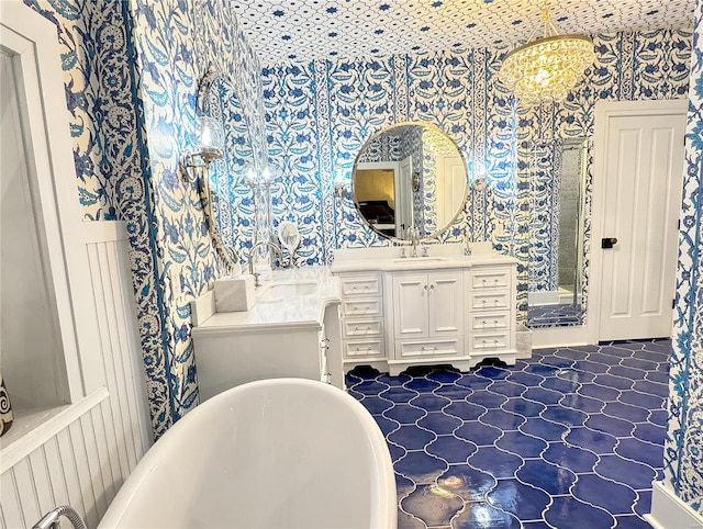 bathroom featuring a tub, tile patterned flooring, and vanity