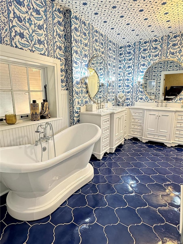 bathroom with a bath, tile patterned floors, and vanity