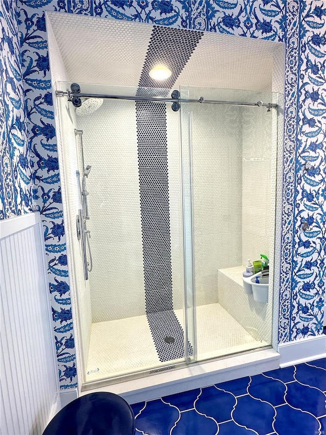 bathroom featuring tile patterned flooring and an enclosed shower