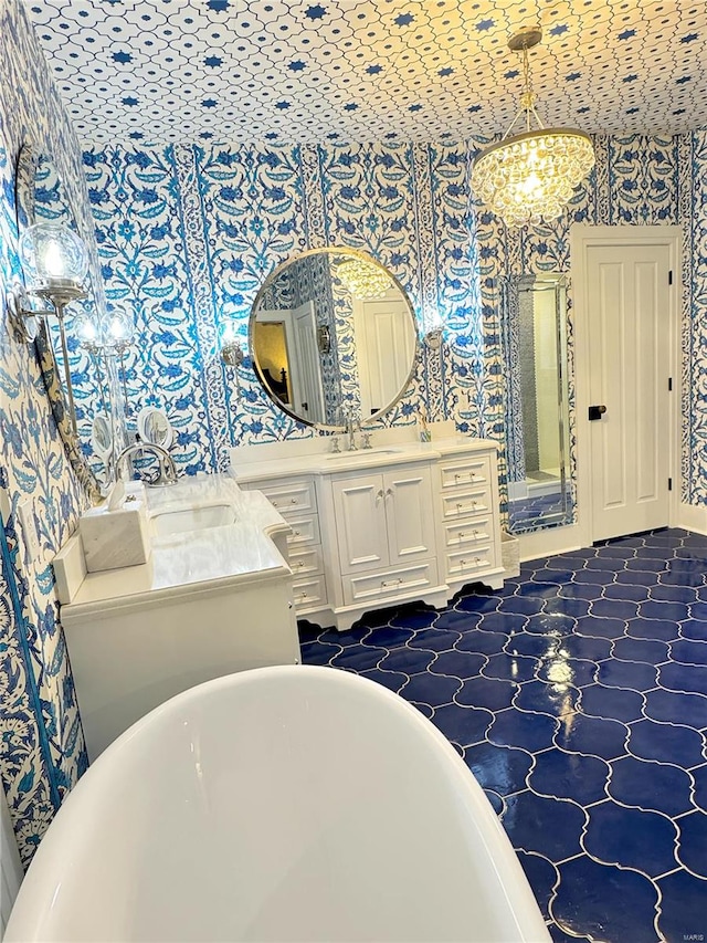 bathroom with a bath, tile patterned floors, and vanity