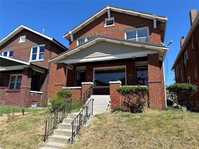 craftsman inspired home featuring a garage, a porch, and a front lawn