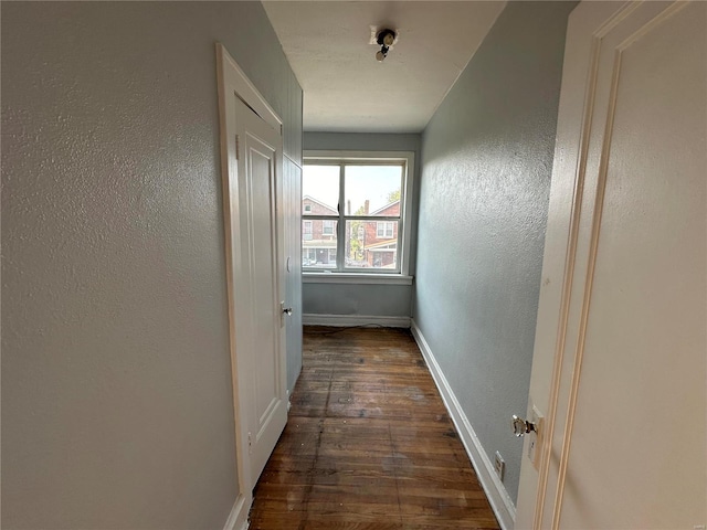 corridor featuring dark wood-type flooring