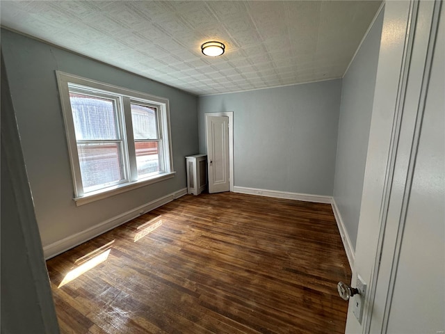 unfurnished room with dark wood-type flooring