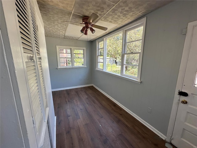 interior space with ceiling fan and dark hardwood / wood-style floors